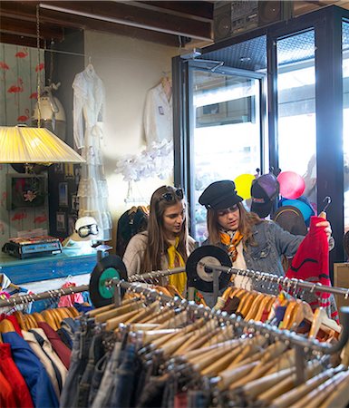 Friends browsing vintage clothes in thrift store Stock Photo - Premium Royalty-Free, Code: 649-09149361