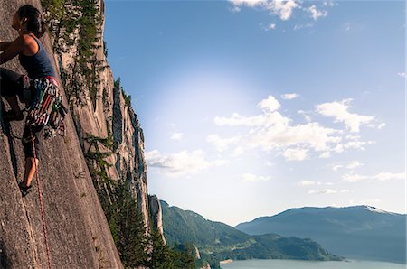 rock climbing - Female rock climber, climbing granite rock (The Chief), low angle view, Squamish, Canada Stock Photo - Premium Royalty-Free, Code: 649-09155693