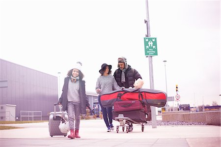 family and vacation and airport - Father with wheeled suitcase and luggage trolley Stock Photo - Premium Royalty-Free, Code: 649-09155740