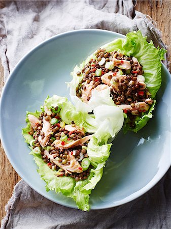 Smoked trout and lentil lettuce cups, on plate, close-up Stock Photo - Premium Royalty-Free, Code: 649-09155975