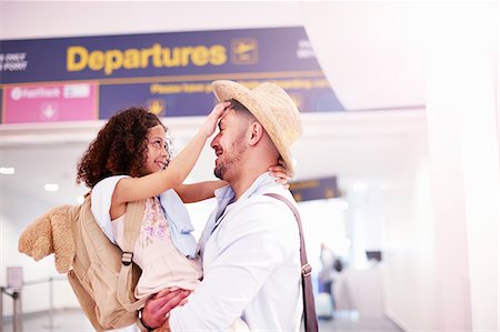 people hugging at airport - Father and daughter hugging at departure lounge of airport Stock Photo - Premium Royalty-Free, Code: 649-09156229