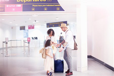 Family standing together at departure lounge of airport Stock Photo - Premium Royalty-Free, Code: 649-09156233