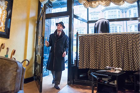 simsearch:649-09158921,k - Male customer in winter coat and trilby arriving in tailors shop Photographie de stock - Premium Libres de Droits, Code: 649-09158900