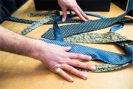 simsearch:400-08031960,k - Customer choosing a tie on tailors shop table, detail of hands Stock Photo - Premium Royalty-Free, Code: 649-09158912