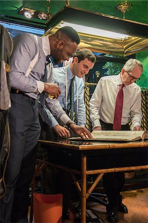 simsearch:649-09158921,k - Tailors and customer looking at handmade swatch book in traditional tailors shop, detail of hands Photographie de stock - Premium Libres de Droits, Code: 649-09158935