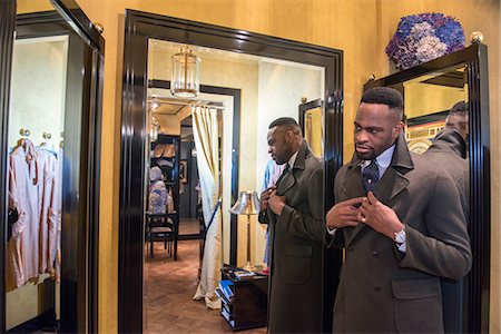 simsearch:649-09158921,k - Young male customer looking in mirror in traditional tailors shop Photographie de stock - Premium Libres de Droits, Code: 649-09158942