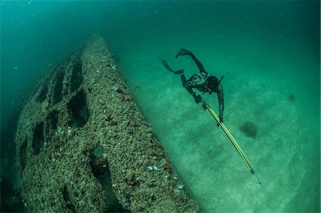 Spearfisherman looking for prey around wreck, Isla Mujeres, Quintana Roo, Mexico Stock Photo - Premium Royalty-Free, Code: 649-09159052