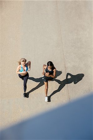 physically fit women wearing shorts - Young women running on road Stock Photo - Premium Royalty-Free, Code: 649-09159255