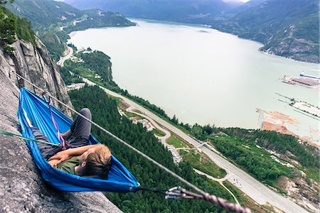 extreme sports and connect - Young male climber reclining in hammock on bellygood ledge, The Chief, Squamish, Canada Stock Photo - Premium Royalty-Free, Code: 649-09159363