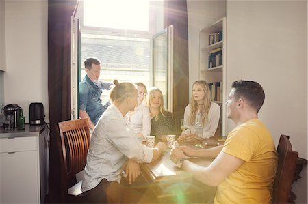 simsearch:614-08392689,k - Group of friends chatting over drinks at home Stock Photo - Premium Royalty-Free, Code: 649-09159491
