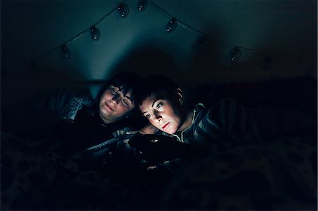 Women in bed in darkness using laptop Stock Photo - Premium Royalty-Free, Code: 649-09166623