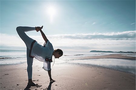 simsearch:614-06116385,k - Woman practising yoga on beach Photographie de stock - Premium Libres de Droits, Code: 649-09166858