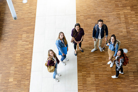 simsearch:649-07064211,k - Male and female university students looking up from university lobby, high angle portrait Fotografie stock - Premium Royalty-Free, Codice: 649-09176695