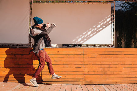 dance coat - Hipster dancing on wooden decking by stage Photographie de stock - Premium Libres de Droits, Code: 649-09177019