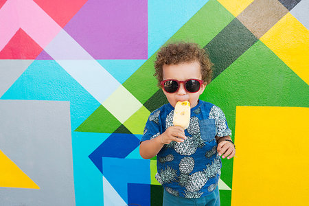 summer kids fun - Toddler eating ice cream, mural in background, Wynwood, Miami, Florida, USA Stock Photo - Premium Royalty-Free, Code: 649-09182061