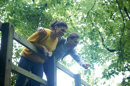 Hiker couple looking over wooden bridge Stock Photo - Premium Royalty-Free, Code: 649-09182367