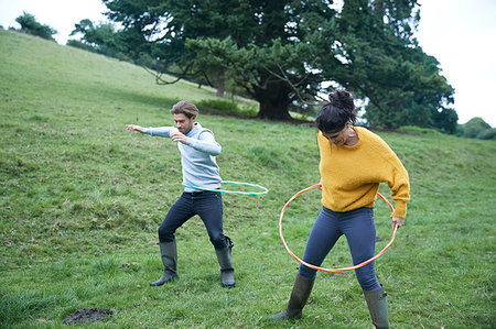 Couple hula hooping in field Stock Photo - Premium Royalty-Free, Code: 649-09182376