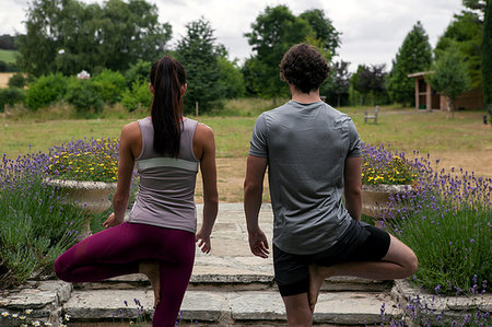 simsearch:649-09230215,k - Man and woman practicing yoga in garden, rear view of tree pose Photographie de stock - Premium Libres de Droits, Code: 649-09195588