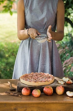 preparation of apple pie - Woman preparing apple pie on table Stock Photo - Premium Royalty-Free, Code: 649-09195948
