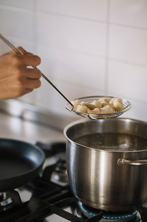 simsearch:695-05770947,k - Potato gnocchi being removed from pot Stock Photo - Premium Royalty-Free, Code: 649-09195975