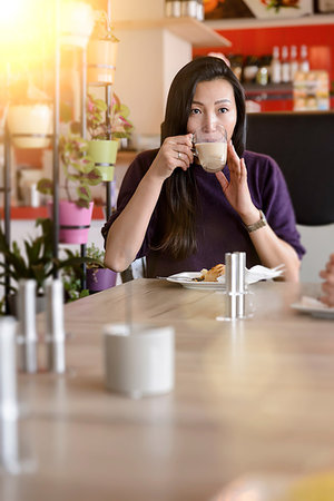 simsearch:649-09213680,k - Mid adult woman drinking coffee in cafe Stock Photo - Premium Royalty-Free, Code: 649-09196511