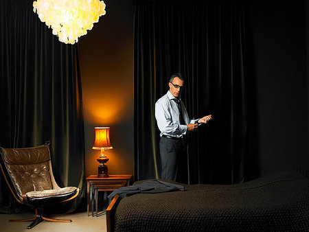 simsearch:614-08865804,k - Man in glasses standing in bedroom Stock Photo - Premium Royalty-Free, Code: 649-09205538