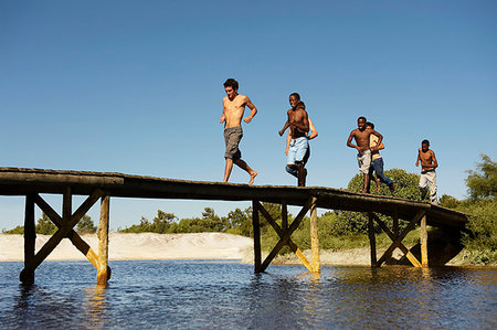 simsearch:649-09205602,k - Group of teenagers running across jetty Stock Photo - Premium Royalty-Free, Code: 649-09205575