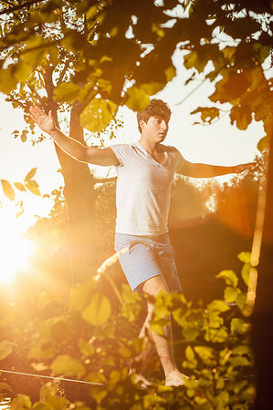 simsearch:700-03179164,k - Man walking on tight rope outdoors Stock Photo - Premium Royalty-Free, Code: 649-09206279