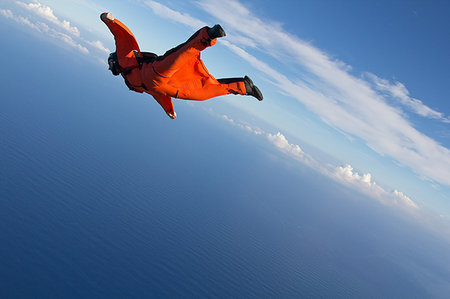 parachute over the blue sky - Wingsuit flying over north shore of Oahu, Hawaii Stock Photo - Premium Royalty-Free, Code: 649-09206797