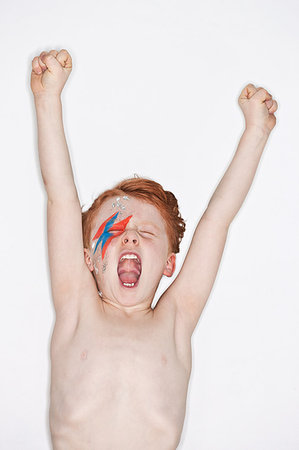 simsearch:649-08563671,k - Red headed boy wearing rock star make-up and cheering Stock Photo - Premium Royalty-Free, Code: 649-09206873