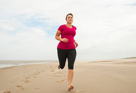 fat women at the beach - Woman running on beach Stock Photo - Premium Royalty-Free, Code: 649-09207105