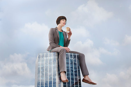 simsearch:614-08875291,k - Oversized businesswoman sitting on skyscraper, low angle view Photographie de stock - Premium Libres de Droits, Code: 649-09207101