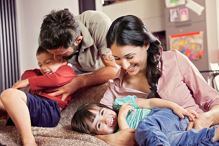 simsearch:614-03080479,k - Family with two children playing on sofa Stock Photo - Premium Royalty-Free, Code: 649-09207170