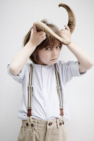 Boy posing with animal horn Stock Photo - Premium Royalty-Free, Code: 649-09207245