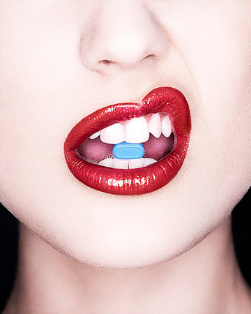Close up of woman's mouth with bright lipstick and pill Stock Photo - Premium Royalty-Free, Code: 649-09207393