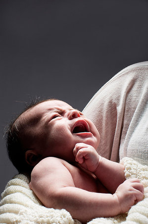 simsearch:400-04829724,k - Mother cradling crying baby son Photographie de stock - Premium Libres de Droits, Code: 649-09207601