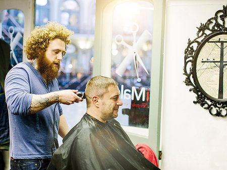 Barber cutting mature mans hair with clippers Stock Photo - Premium Royalty-Free, Code: 649-09207660