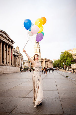 simsearch:649-09207748,k - Young woman in evening gown holding up balloons, Trafalgar Square, London, UK Photographie de stock - Premium Libres de Droits, Code: 649-09207731
