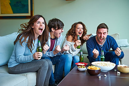 Group of friends watching sport in living room Stock Photo - Premium Royalty-Free, Code: 649-09207979