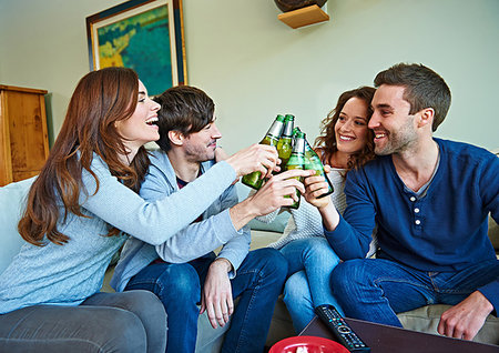 Group of friends watching sport in living room Stock Photo - Premium Royalty-Free, Code: 649-09207980