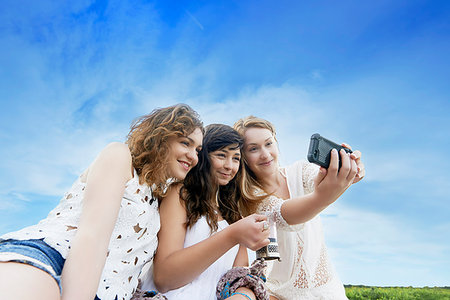simsearch:649-08118794,k - Three young women in field posing for selfie on smartphone Stock Photo - Premium Royalty-Free, Code: 649-09208049