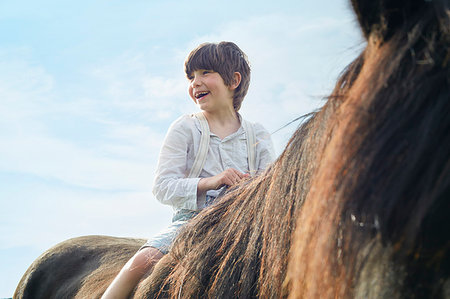 simsearch:649-09003830,k - Close up cropped shot of boy on horse Stock Photo - Premium Royalty-Free, Code: 649-09208065