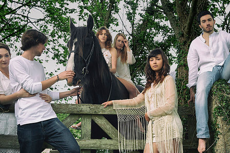 Portrait of six young adults and horse at forest gate Stock Photo - Premium Royalty-Free, Code: 649-09208068