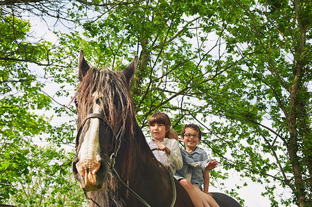 simsearch:649-09003830,k - Low angle view of three boys riding on horse Stock Photo - Premium Royalty-Free, Code: 649-09208072