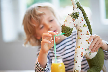 simsearch:649-09139263,k - Young boy pretending to feed drink to soft toy Stock Photo - Premium Royalty-Free, Code: 649-09208762
