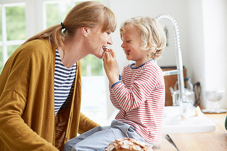 Young boy feeding mother a sweet treat Stock Photo - Premium Royalty-Free, Code: 649-09208771