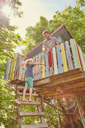 Father and two sons, painting tree house Stock Photo - Premium Royalty-Free, Code: 649-09208833