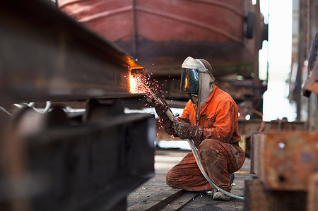Welder welding girder in shipyard workshop Stock Photo - Premium Royalty-Free, Code: 649-09209171
