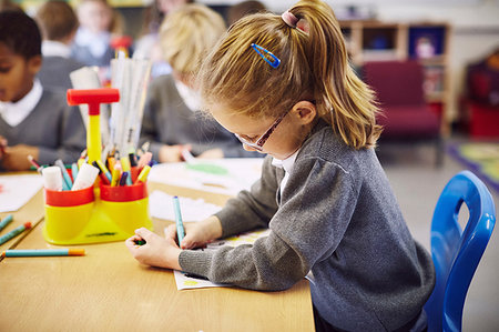 simsearch:649-09209379,k - Girl concentrating on drawing in elementary school classroom Stock Photo - Premium Royalty-Free, Code: 649-09209380