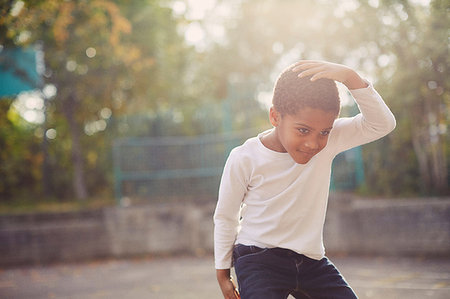 simsearch:614-05523145,k - Elementary schoolboy dancing in school playground Stock Photo - Premium Royalty-Free, Code: 649-09209400